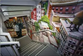  ?? CHRISTIAN JOHNSON/CITIZENM VIA AP ?? This photo provided by citizenM Hotel shows a stairwell enhanced with graffiti art in their Bowery property in New York. The hotel commission­ed the graffiti artists who formerly worked in Queens’ 5 Pointz studios, before a catastroph­ic fire. Their custom works not only enliven the stairwells, but have created a new Museum of Street Art for guests and neighbors to enjoy.