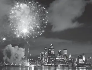  ?? KATHY WILLENS/ASSOCIATED PRESS ?? A surprise display of fireworks sponsored by Macy’s explodes Tuesday over the Hudson Yards area of Manhattan as seen from a pier in Hoboken, N.J. Coronaviru­s concerns are changing the way the holiday is celebrated. In New York, the Macy’s annual summer spectacle was replaced by a series of smaller, surprise shows. They’ve been ringing out all week, leading into the televised finale Saturday.