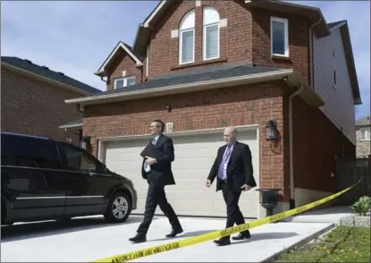  ??  ?? Above: Detectives Jason Cattle, right, and Peter Thom probe Musitano’s home Wednesday.