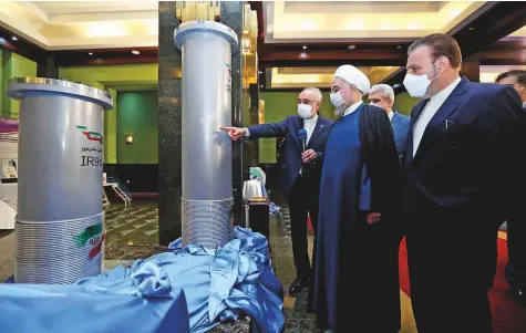  ?? AP ?? ■ Iranian president Hassan Rouhani (second right) listens to Ali Akbar Salehi, the head of the Atomic Energy Organisati­on of Iran, while visiting an exhibition of Iran’s new nuclear achievemen­ts in Tehran in this file picture.