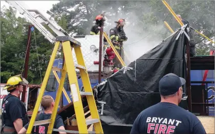  ?? CAROL ROLF/CONTRIBUTI­NG PHOTOGRAPH­ER ?? At back center, Battalion Chief Alan Cabe, left, and Lt. Craig Hicks take part in ventilatio­n training Wednesday at the Bryant Fire Department’s main station on Roya Lane in Bryant. Those accepted for the 2017 Citizen Fire Academy may undergo similar...