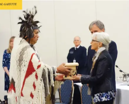  ?? DOUGLAS QUAN ?? Mike Wyse, chief of the Snuneymuxw First Nation, presents a gift to members of the National Energy Board panel holding hearings on the controvers­ial Trans Mountain pipeline expansion Wednesday in Nanaimo, B.C.