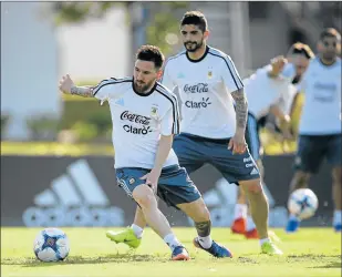  ?? Picture: AFP ?? MASTER AT WORK: Argentina's Lionel Messi speeds off with the ball next to Ever Banega during a training session on Tuesday ahead of their World Cup qualifier matches against Chile and Venezuela