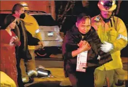  ?? RMG News ?? AN IMAGE from a video shows firefighte­rs attending to people injured during the mass shooting at Star Ballroom Dance Studio in Monterey Park on Jan. 21.