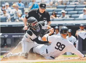  ?? Frank Franklin II, The Associated Press ?? Rockies catcher Tony Wolters tags out New York’s Aaron Judge in front of home plate umpire Chris Conroy during the first inning Saturday at Yankee Stadium.