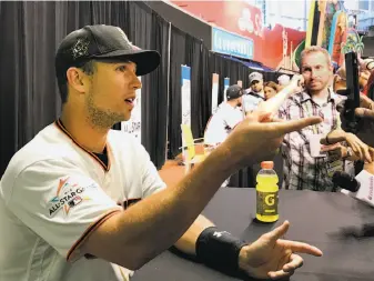  ?? John Shea / The Chronicle ?? Buster Posey speaks with the media before the All-Star workout. He’ll be the cleanup hitter for manager Joe Maddon, who praised the Giants’ catcher as the NL lineup was announced.