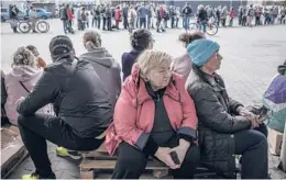  ?? FINBARR O’REILLY/THE NEW YORK TIMES ?? People wait to receive humanitari­an aid Thursday in Kharkiv, Ukraine. A $40 billion package of further U.S. aid stalled the same day in the Senate.