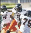  ?? JIM GENSHEIMER — STAFF ?? Pittsburg’s Jalen Mitchell, center, celebrates his intercepti­on with teammates Jaden Tauanu’u (7) and De’jon Benton (79) during Saturday’s game against Serra.