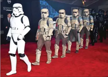  ?? GETTY IMAGES/AFP ETHAN MILLER/ ?? Stormtroop­er characters march down the red carpet at the premiere of Walt Disney Pictures and Lucasfilm’s at the Pantages Theater on Saturday in Hollywood, California.