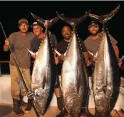  ??  ?? Capt. Pat Cavanaugh (left) and the Pacific Dawn crew with three 200-plus-pound bluefin tuna.