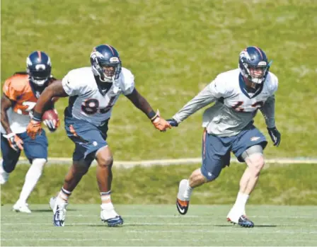  ??  ?? Broncos tight end Dominique Jones, left, and tight end/fullback Joe Don Duncan keep in contact while running through kickoff drills Tuesday. The Broncos may need better team chemistry this season to go deeper into the playoffs. John Leyba, The Denver...