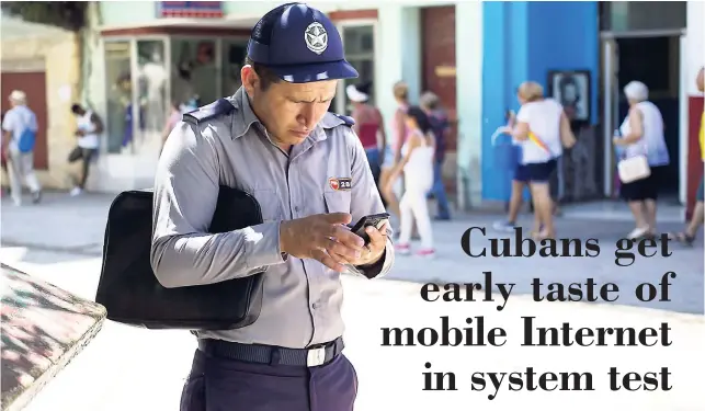  ?? AP ?? A policeman gets connected to the internet using his phone in Havana, Cuba, on Wednesday, August 22. The state telecommun­ications company of Cuba launched on Wednesday the latest, and most extensive, of a recent series of test runs of a mobile network.