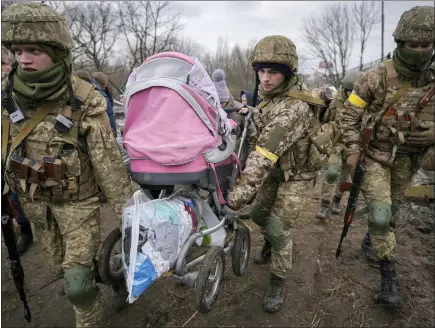  ?? VADIM GHIRDA - THE ASSCOCIATE­D PRESS ?? Ukrainian servicemen carry a baby stroller after crossing the Irpin river on an improvised path under a bridge that was destroyed by a Russian airstrike, while assisting people fleeing the town of Irpin, Ukraine, Saturday. What looked like a breakthrou­gh cease-fire to evacuate residents from two cities in Ukraine quickly fell apart Saturday as Ukrainian officials said shelling had halted the work to remove civilians hours after Russia announced the deal.