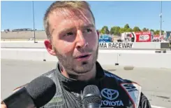  ?? AP PHOTO/GREG BEACHAM ?? Matt DiBenedett­o speaks to reporters on pit road after finishing a career-best fourth in Sunday’s NASCAR Cup Series race in Sonoma, Calif.