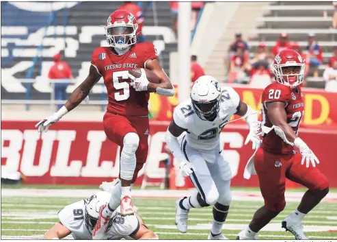  ?? Gary Kazanjian / Associated Press ?? Fresno State’s Jalen Cropper (5) runs past UConn’s Collin McCarthy (91) during the first half on Saturday.