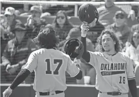  ?? ANNIE RICE/AVALANCHE-JOURNAL ?? OSU’s Tyler Wulfert (17) and Beau Sylvester (18) celebrate Wulfert’s home run against Texas Tech on Saturday in Lubbock.