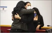  ?? KELSEY KREMER — THE DES MOINES REGISTER ?? Des Moines Register reporter Andrea Sahouri, facing, hugs her mother, Muna Tareh-Sahouri, after being found notguilty at the conclusion of her trial at the Drake University Legal Clinic in Des Moines, Iowa, on Wednesday.