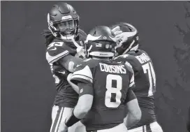  ?? CHARLES TRAINOR JR. ctrainor@miamiheral­d.com ?? Vikings running back Dalvin Cook, left, a former Miami Central star, celebrates his 21-yard, fourth-quarter touchdown run with teammates. Cook rushed for 136 yards on 19 carries.