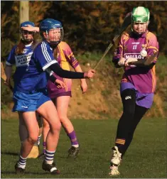  ??  ?? Ella Dalton of Wexford strikes as Jade Bergin (Laois) closes in.