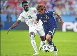  ??  ?? Japan’s midfielder Takashi Inui (R) vies with Senegal’s forward Ismaila Sarr on Sunday.