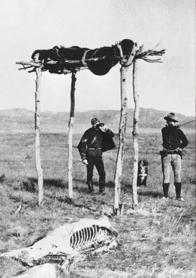  ??  ?? NWMP officers at the site where a Sioux warrior mortally wounded at Little Bighorn received the honour of a traditiona­l air burial at Eastend, North-West Territorie­s. His horse was placed below him.