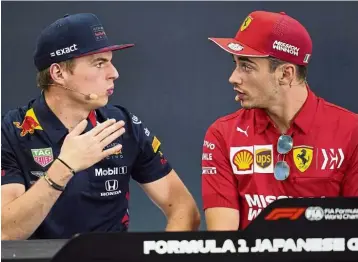  ?? — AP ?? Qualifying on race day: Red Bull driver Max Verstappen and Ferrari driver Charles Leclerc of Monaco look at each other during a press conference for the Japanese Formula One Grand Prix at Suzuka Circuit in Suzuka yesterday.