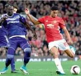  ?? — AFP ?? Manchester United striker Marcus Rashford (right) scores in their Europa League quarter-final second leg match against Anderlecht at Old Trafford on Thursday. Man United won 2-1 to advance on a 3-2 aggregate score.