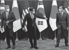  ?? YONHAP ?? Noh Kyu-duk (center), the ROK’s special representa­tive for Korean Peninsula peace and security affairs, appears with Sung Kim (left), US special representa­tive for DPRK issues, and Takehiro Funakoshi, head of the Japanese Foreign Ministry’s Asian and Oceanian Affairs Bureau, before talks in Seoul on Monday.