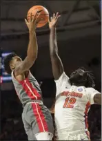  ?? The Associated Press ?? NOT TODAY: Gardner-Webb guard David Efianayi (11) has his shot blocked by Florida center Gorjok Gak (12) during the first half of Monday’s game in Gainesvill­e, Fla..