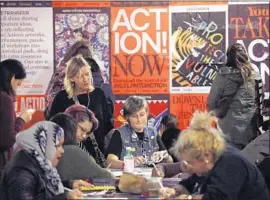  ?? Genaro Molina Los Angeles Times ?? WOMEN in Los Angeles make signs for Saturday’s downtown march. Hundreds of marches and events are planned for Saturday and Sunday across the country.