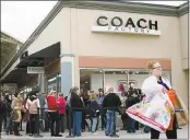  ?? ASSOCIATED PRESS FILE ?? Shoppers line up outside a Coach factory outlet store in Monroe, Ohio, in 2015. The storied company announced Wednesday that it is changing its name to Tapestry.
