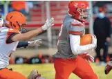  ?? JIM THOMPSON/JOURNAL ?? Ayden Madrid evades the reach of a Gallup player and heads for the end zone in a game on March 13. The senior will play football at Fort Lewis College in Durango, Colo.