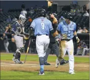  ?? PHOTO BY BERT HINDMAN ?? Blue Crabs third baseman Jose Lozada, pictured far right, is congratula­ted by teammate Edwin Garcia after his eventual-game winning solo home run in the bottom of the eighth inning to beat the Bridgeport Bluefish 4-3 in the first of a three-game series...