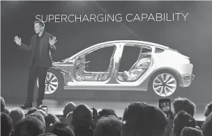  ??  ?? Tesla Motors Inc. CEO Elon Musk speaks at the March 2016 unveiling of the Model 3 at the Tesla Motors design studio in Hawthorne, Calif. Two years later, investors are concerned about slow Model 3 production and Musk’s behavior, among other things.