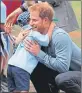  ??  ?? Prince Harry hugs Luke Vincent, 5, at Dubbo Airport in Australia