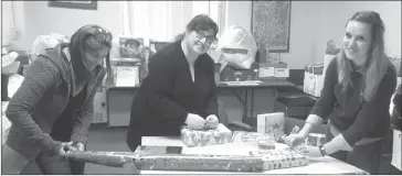  ?? SUBMITTED BY LDWC ?? Left to right - Melissa Gardner, Kathryne Owen, Kristen Dempsey wrapping up the Secret Santa gifts collected for the 2017 campaign.