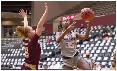  ?? (Photo courtesy UALR Athletics) ?? UALR’s Teal Battle (right) goes up for a shot Friday while being defended by Texas State’s Gabby Standifer during the Trojans’ 62-51 victory over the Bobcats at the Jack Stephens Center in Little Rock. Battle led the Trojans with 20 points.