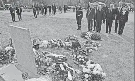  ?? Lionel Bonaventur­e AFP/Getty Images ?? FRENCH OFFICIALS leave a wreath at a memorial to those killed in the March 24 disaster. New data upheld the belief that the plane crash was deliberate.