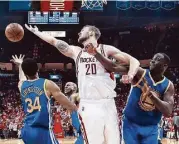  ?? Michael Ciaglo / Houston Chronicle ?? The Rockets’ Donatas Motiejunas, center, had 14 points and 13 rebounds in Game 3 on Thursday.