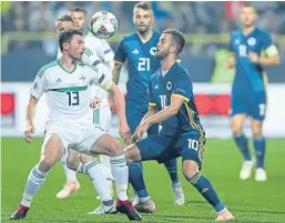  ?? Picture: PA. ?? Northern Ireland’s Corry Evans, left, challenges Bosnia and Herzegovin­a’s Miralem Pjanic.