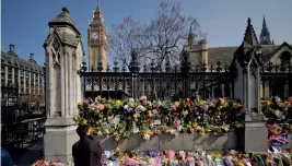  ??  ?? Floral tributes to the victims of the March 22 terror attack are seen outside the Houses of Parliament in Westminste­r on Monday. —