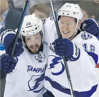  ?? KATHY WILLENS/THE ASSOCIATED PRESS ?? Lightning forwards Nikita Kucherov, left, and Ondrej Palat celebrate Palat’s goal against the Rangers in Game 7 of the Eastern Conference Final on Friday. The Lightning won 2-0.