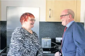  ??  ?? House guest Kevin Stewart MSP with Blackthorn Place tenant Karen Leith in her home