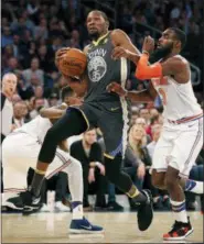  ?? KATHY WILLENS — THE ASSOCIATED PRESS ?? Golden State Warriors forward Kevin Durant (35) collides with New York Knicks guard Frank Ntilikina (11) and forward Tim Hardaway Jr. (3) during the first half of an NBA basketball game, Monday in New York.