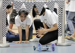  ??  ?? Off they go!: The Elastic Band Car Race saw teams designing and building an elastic car that could literally go the distance.