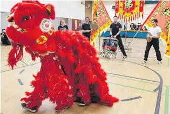  ??  ?? Students practise with the Sheung Kung Fu Club’s new children’s lion ahead of lunar new year performanc­es in Chinatown on Sunday.