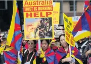  ?? PHOTO: REUTERS ?? Inflamed . . . Hundreds of Tibetans in Australia march through the centre of Sydney yesterday to mark the 58th anniversar­y of China’s presence in Tibet.