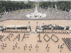  ??  ?? Clockwise from main: the Red Arrows take part in the flypast over Buckingham Palace; the Duke and Duchess of Cambridge, and the Duke and Duchess of Sussex watch on; RAF members gather at Horse Guards Parade; personnel form the RAF 100; the Queen enjoys...