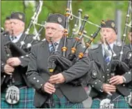  ??  ?? Members of the Syracuse Scottish Pipe Band perform as the make their way along the parade route during the Memorial Day remembranc­e in Oneida.