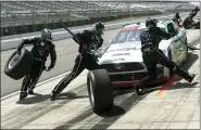  ?? MATT SLOCUM — THE ASSOCIATED PRESS ?? Crew members hustle to service the car of Austin Cindric in a pit stop during the NASCAR Xfinity Series auto race at Pocono Raceway Sunday in Long Pond, Pa.